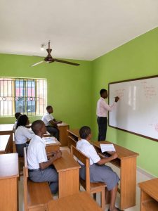 Teacher writing on the whiteboard during a lesson at Enthusia College
